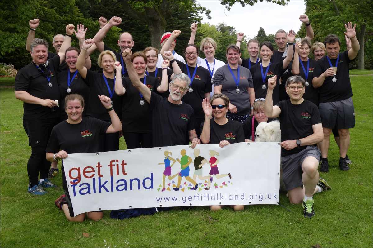 photo of a group of Couch to 5k graduates celebrating behind the Recreational Running banner.