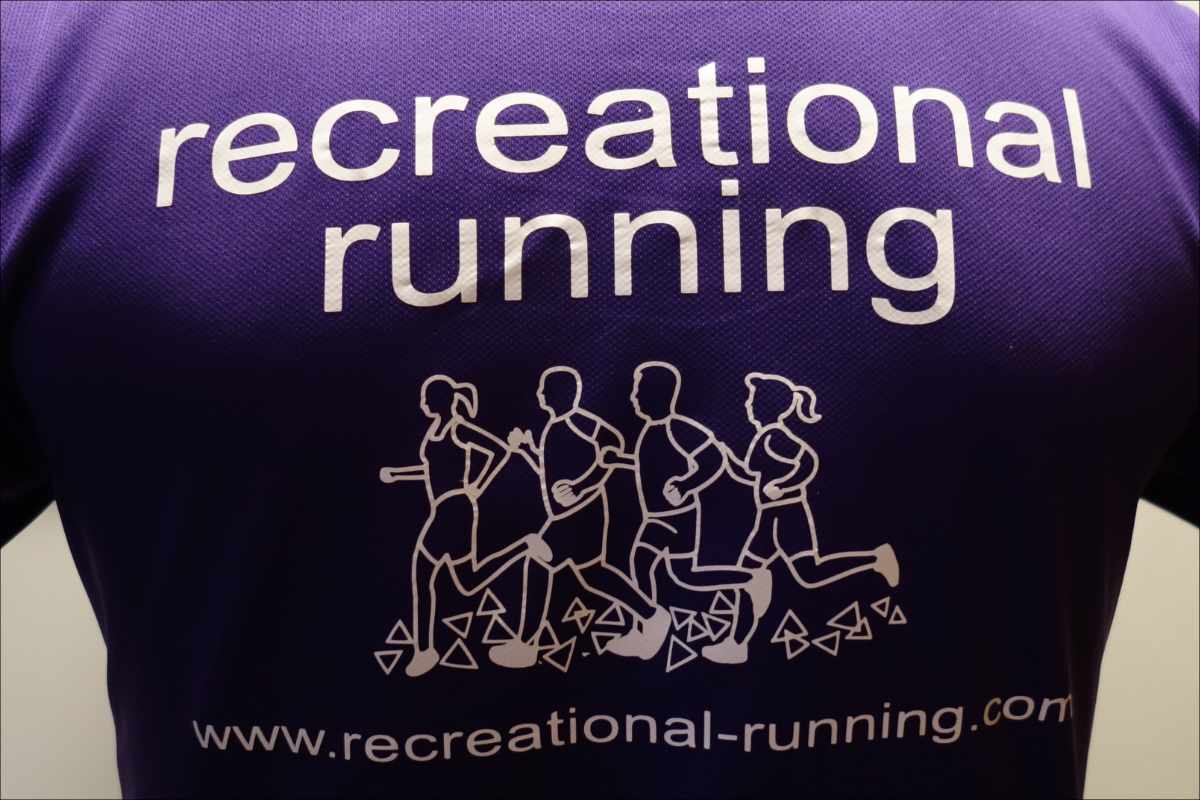 photo of the back of a purpole t-shirt, with the Recreational Running name and logo.